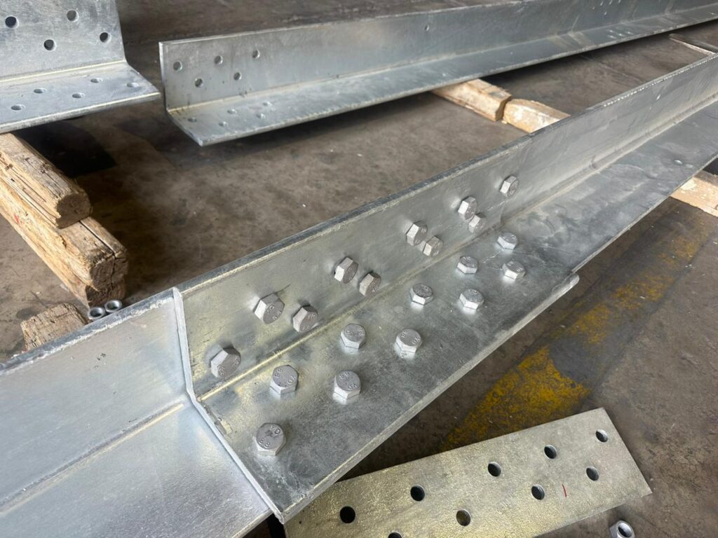 Steel angle members with bolted connection plates in a supplied historical photograph.