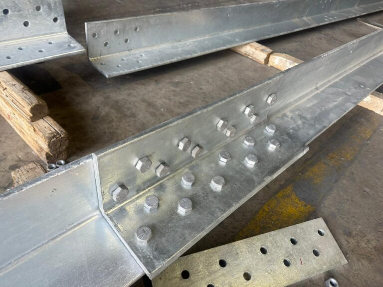 Steel angle members with bolted connection plates in a supplied historical photograph.